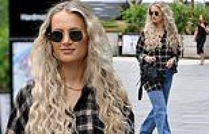 Molly-Mae Hague cuts a laid-back figure in an oversized plaid shirt and jeans ...