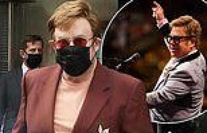 Elton John looks incredibly elegant in a wine suit after he announces new dates ...