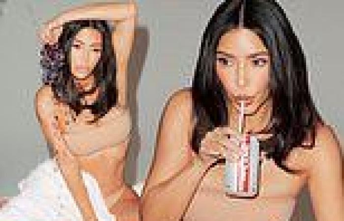 Kim Kardashian models a nude thong and a bandeau as she sips on diet coke in ...