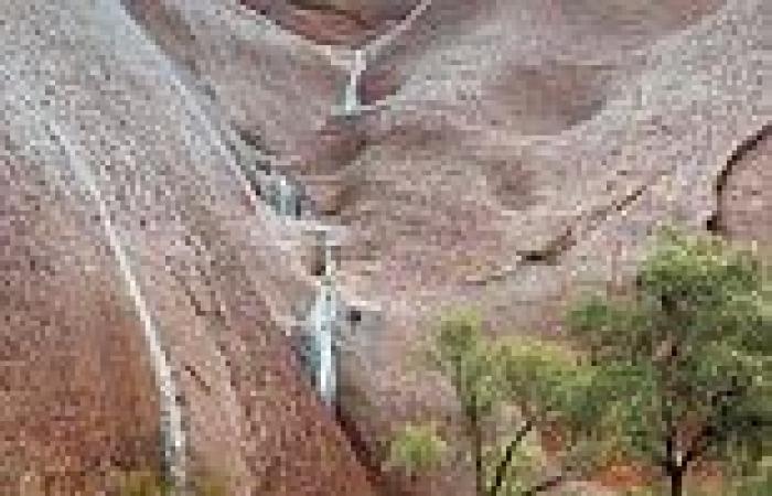 Moment water cascades down Uluru as torrential rain hits the Northern Territory 