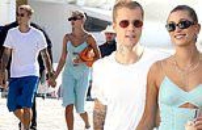Justin Bieber lovingly holds hands with his stunning wife Hailey Bieber as they ...