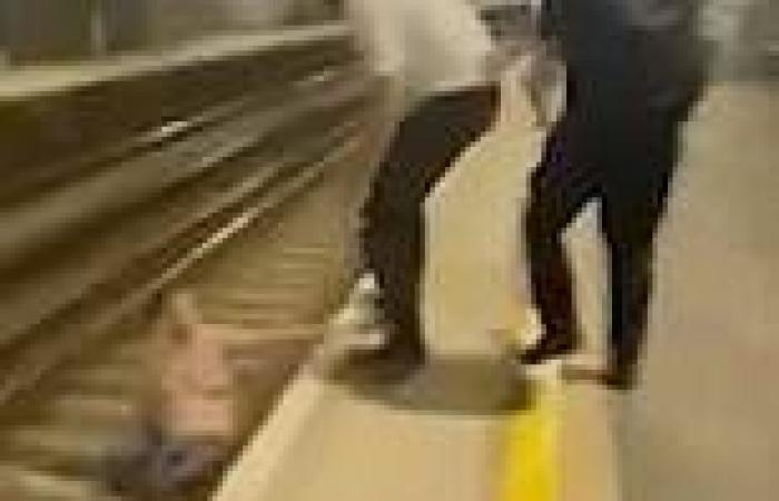 Heart-stopping moment 'drunk' man stumbles onto railway tracks