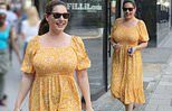 Kelly Brook looks bright and breezy in a floral yellow summer dress as she ...