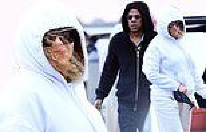 Beyonce covers up in a white hoodie and wide leg pants as she boards a boat in ...
