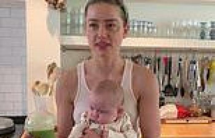 Amber Heard poses in a kitchen with her baby girl Oonagh who was born via ...