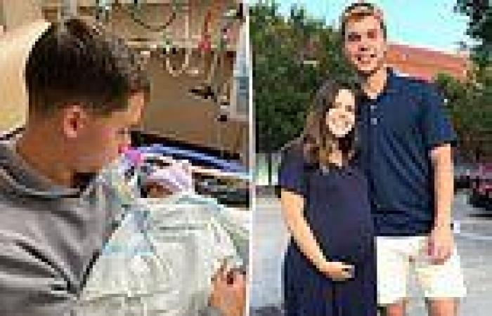 Dad, 21, cradles his newborn son after pregnant wife, 22, was killed when ...