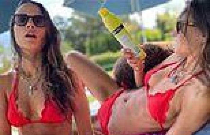 Jordana Brewster shows off her fit figure in a red bikini by her pool.