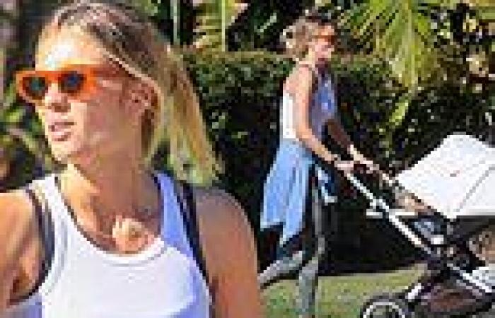 Elyse Knowles is every inch the doting mother as she enjoys a stroll with her ...