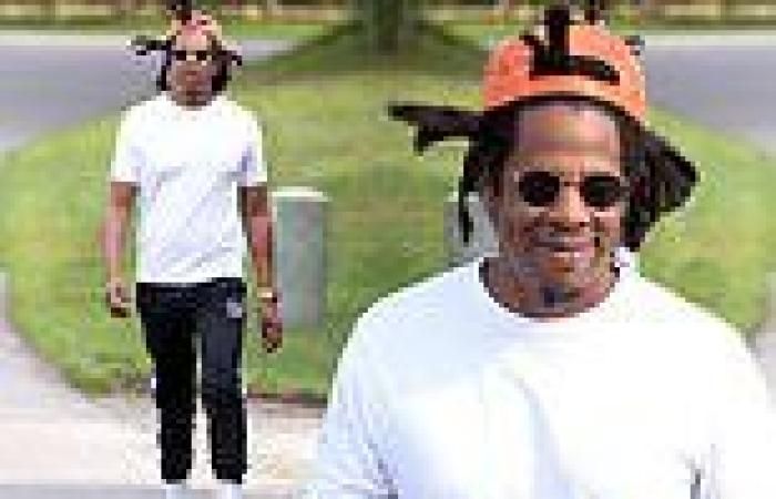 Jay-Z flashes a smile as he enjoys a walk near his Hamptons vacation home ...