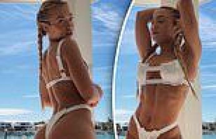 Tammy Hembrow flaunts her washboard abs and famous derrière in a bikini