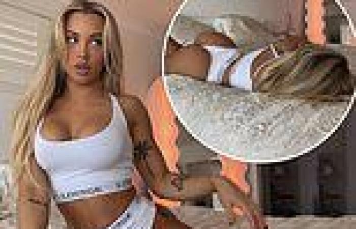 Tammy Hembrow writhes on her bed in white underwear
