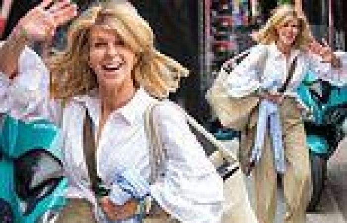 Kate Garraway cuts a relaxed figure in beige wide-leg trousers and a white ...