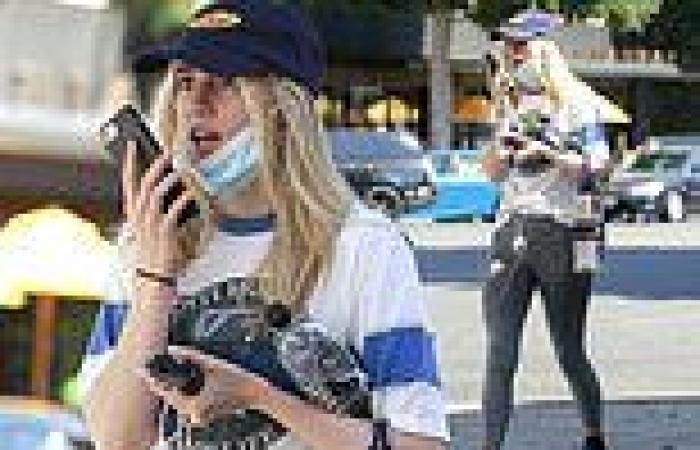 Suki Waterhouse puts her toned physique on display in a ripped T-shirt and ...