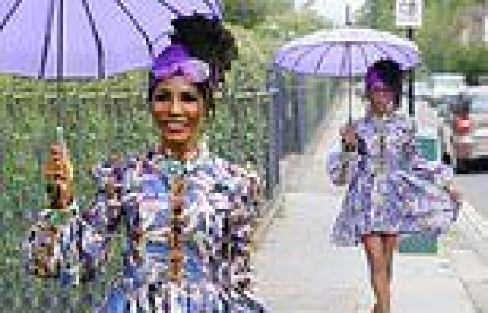 Sinitta flashes her enviable legs in a patterned purple dress