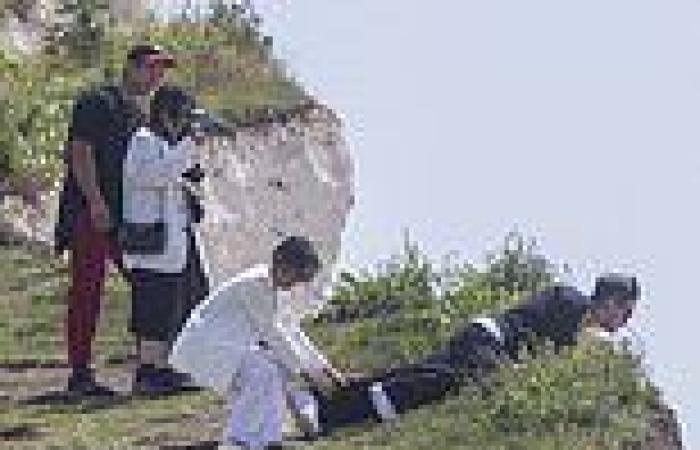 Dicing with death... for a selfie: Tourists pose for photographs on edge of ...