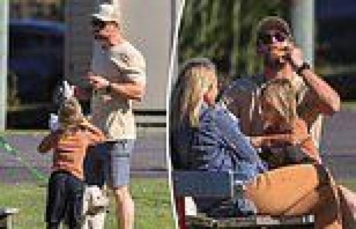 Chris Hemsworth scoffs down a sausage sandwich at his son's weekend sports game ...