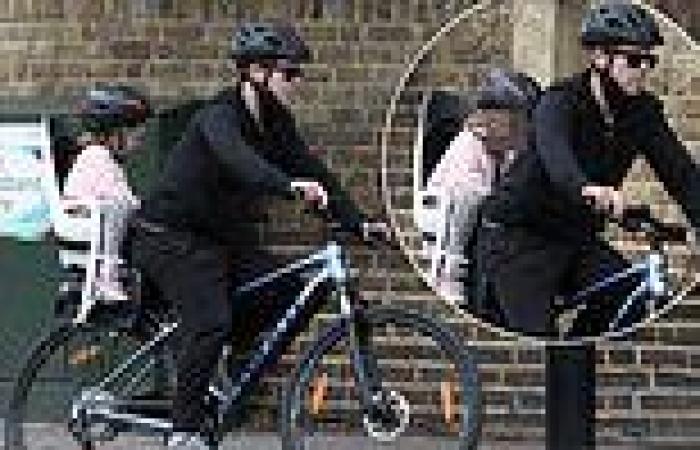Declan Donnelly secures Isla, two, onto the back of his bike for ...