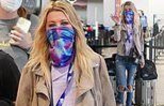 Tara Reid cuts a casual figure in ripped jeans as she arrives back in LA with ...