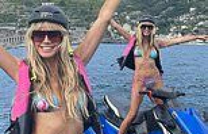 Heidi Klum, 48, shows off her toned frame in a skimpy bikini as she poses on a ...