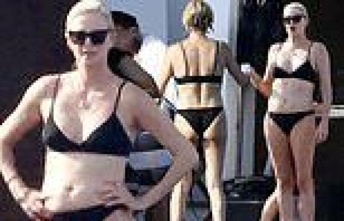 Charlize Theron stuns in a black bikini as she larks about on luxury yacht with ...