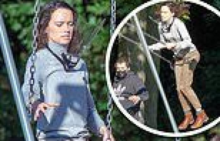 Daisy Ridley looks joyful as she larks around on the swings on a break from ...