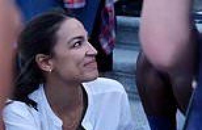 Moment AOC puts her mask on for group photo op only to whip it off a minute ...