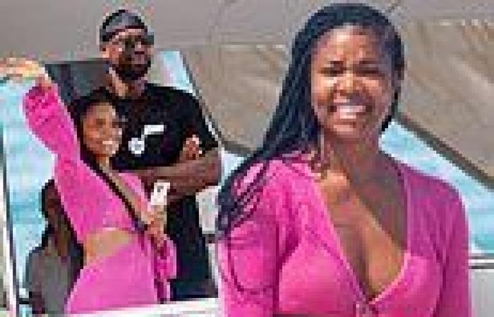 Gabrielle Union rocks a neon pink cut-out dress as she enjoys luxurious holiday ...