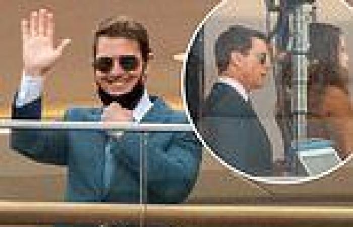 A dapper Tom Cruise waves to fans as filming for Mission Impossible 7 continues