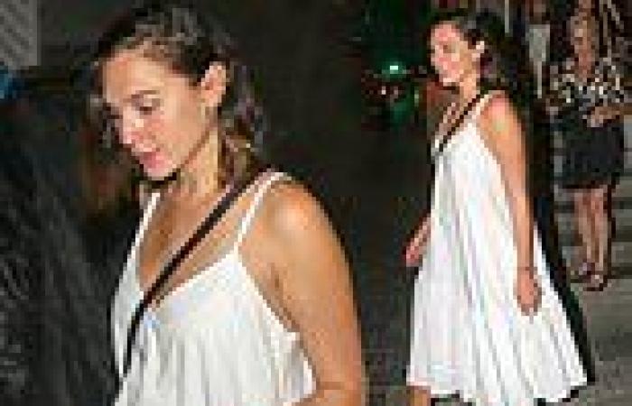 Gal Gadot puts on a stylish display in a plunging white maxi dress as she heads ...
