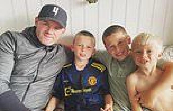 Wayne Rooney poses proudly with his three eldest sons