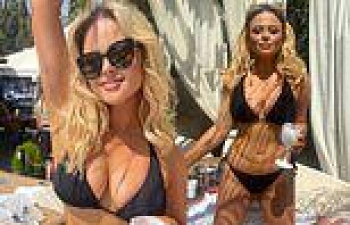 Emily Atack shows off her incredible curves in a tiny black bikini