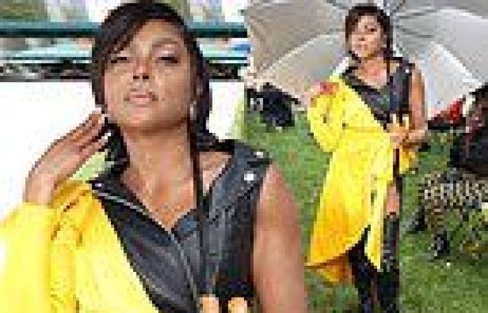 Taraji P. Henson stays dry by keeping a large umbrella with her while attending ...