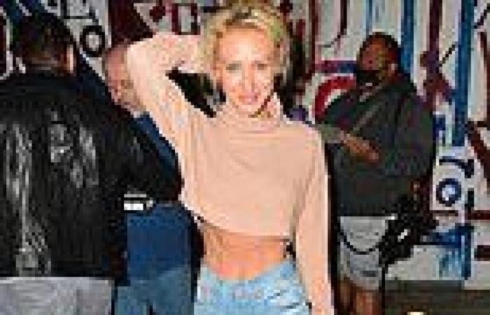 Former Neighbours star Nicky Whelan shows off her six-pack abs in a crop top