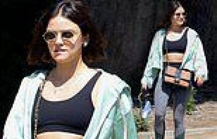 Lucy Hale looks ab fab as she showcases her toned midriff in her sports bra