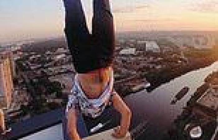 Adrenaline junkie does handstand on roof of Moscow skyscraper before slipping ...
