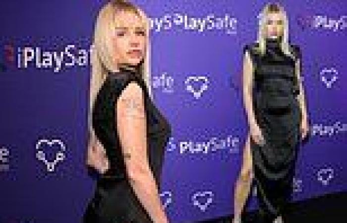 Lottie Moss puts on a leggy display in a thigh-split black satin gown at app ...