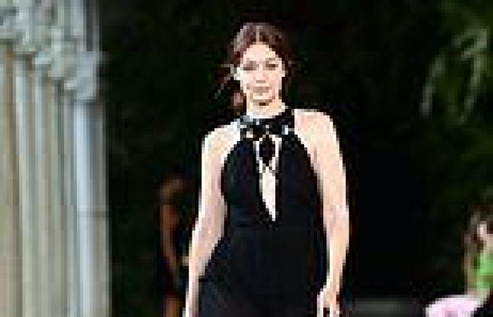 Gigi Hadid vamps it up in a plunging black gown for the Alberta Ferretti show ...
