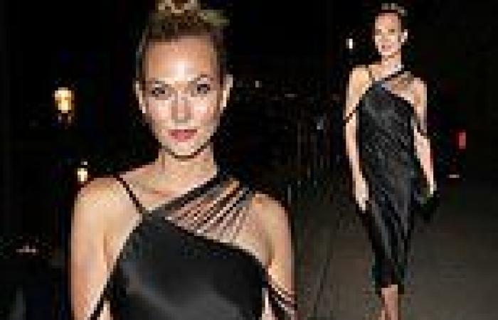 Karlie Kloss slips into a sensational satin black dress as she arrives at the ...