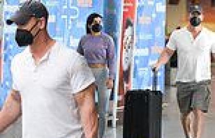 John Cena flashes his muscular biceps while wheeling luggage at airport with ...