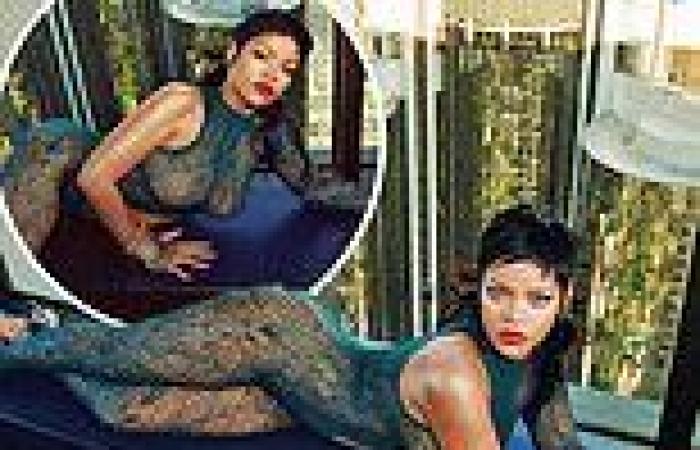 Rihanna turns up the heat as she poses in a high rise with a cityscape behind ...