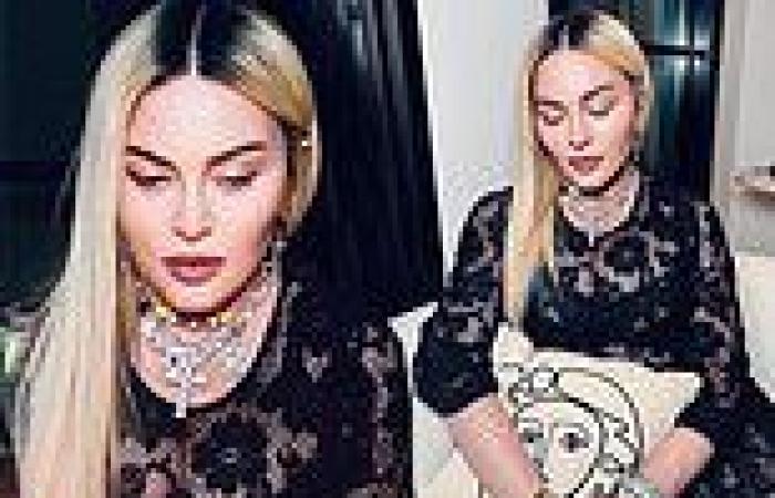 Madonna shows off her sense of style while contrasting a black lace dress with ...