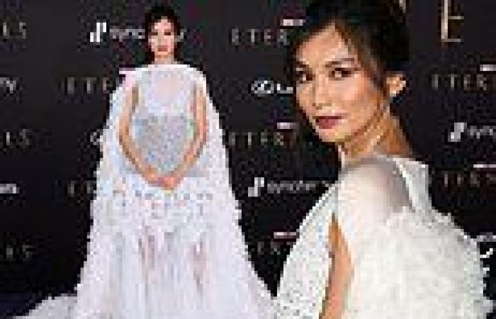 Gemma Chan looks gorgeous in diaphanous white gown with ostrich feather cape at ...