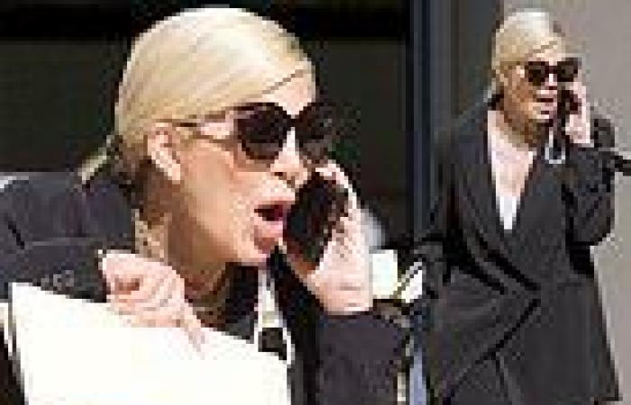 Tori Spelling has VERY heated phone conversation as she leaves lawyers office ...