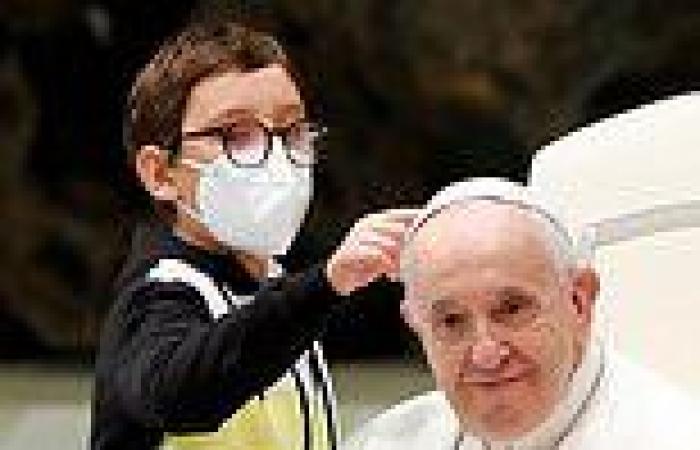 Moment a boy with learning difficulties climbs on stage to meet the Pope