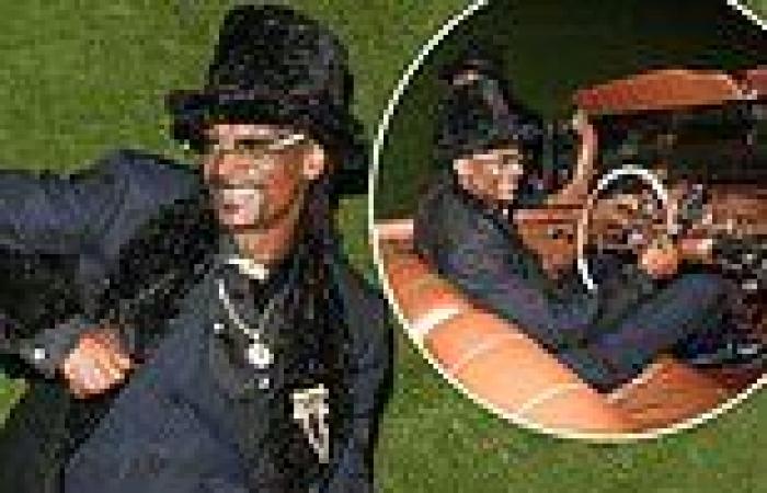 Snoop Dogg grins at his 50th birthday in a fluffy top hat as he's gifted a ...