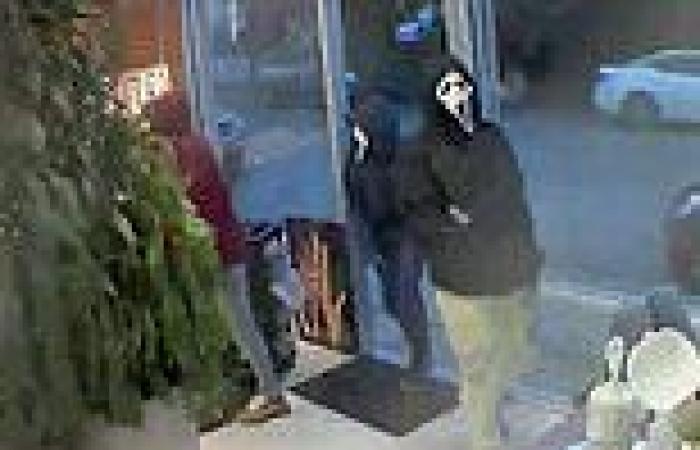 Three men wearing SCREAM masks point guns at workers at a Seattle hair salon