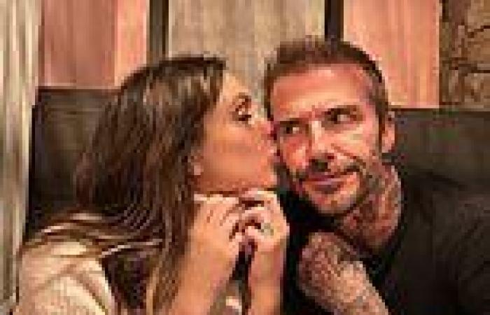 Victoria Beckham plants a kiss on husband David's cheek during family dinner