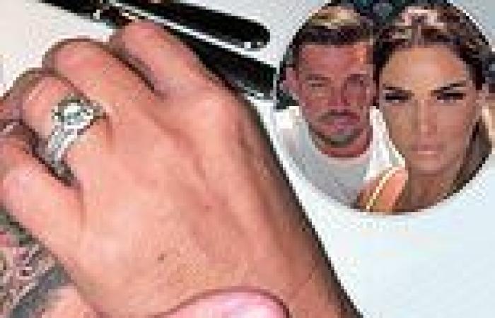 Katie Price flashes her engagement ring as she holds hands with fiancé Carl ...
