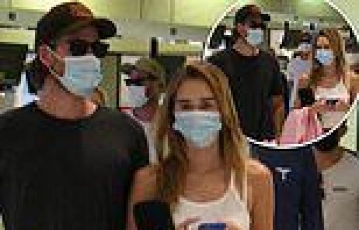 Liam Hemsworth and Gabriella Brooks look casual cool as they jet into Sydney
