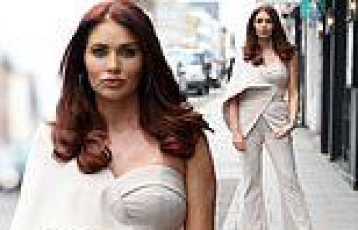 Amy Childs oozes glamour in an eye-catching caped trouser suit as she films The ...